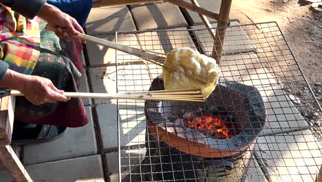 cooking rice crisps over an open flame