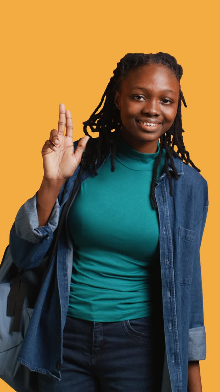 Young African American Woman Waving and Showing Peace Sign