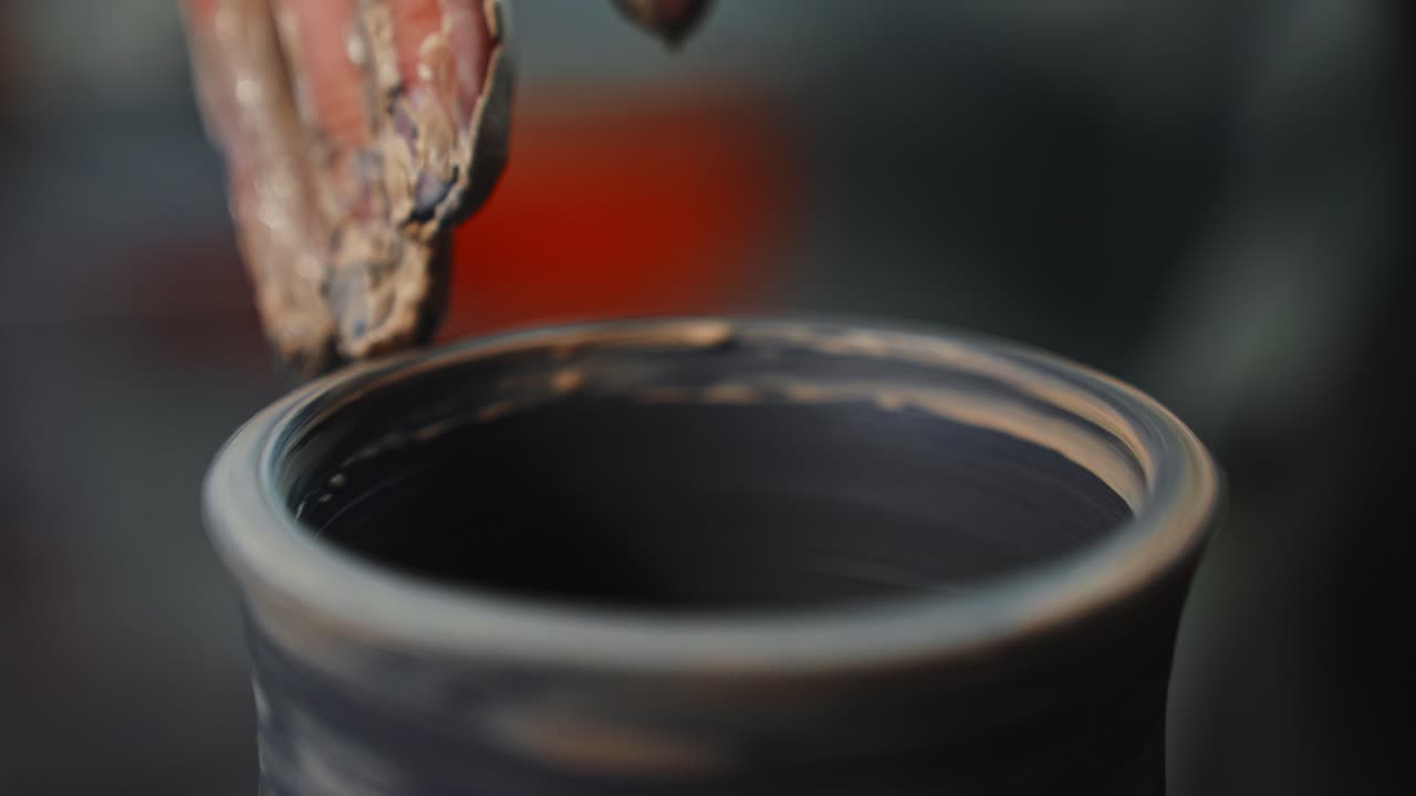 Potter Shaping Clay on a Wheel