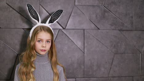 portrait of a cute little girl dressed in ears easter bunny, happy baby waiting for the holiday