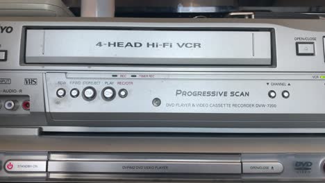 home video vhs tape being loaded and ejected from vcr 1990s