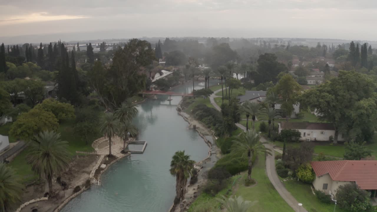 Aerial view of a tranquil river flowing through a residential area