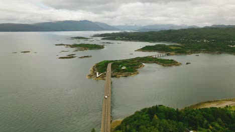 Connecting-Scotland's-Highlands-to-Islands:-Aerial-Sweep-of-Skye-Bridge,-Kyle-of-Lochalsh-and-Loch-Alsh-in-Scotland,-United-Kingdom