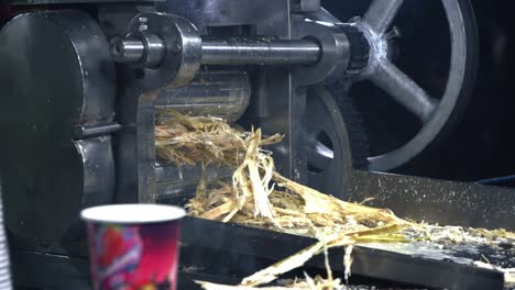 sugarcane juice making in machine closeup view