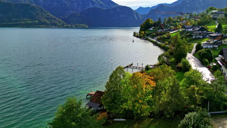 beautiful small town on lake coast surrounded with mountains, aerial view