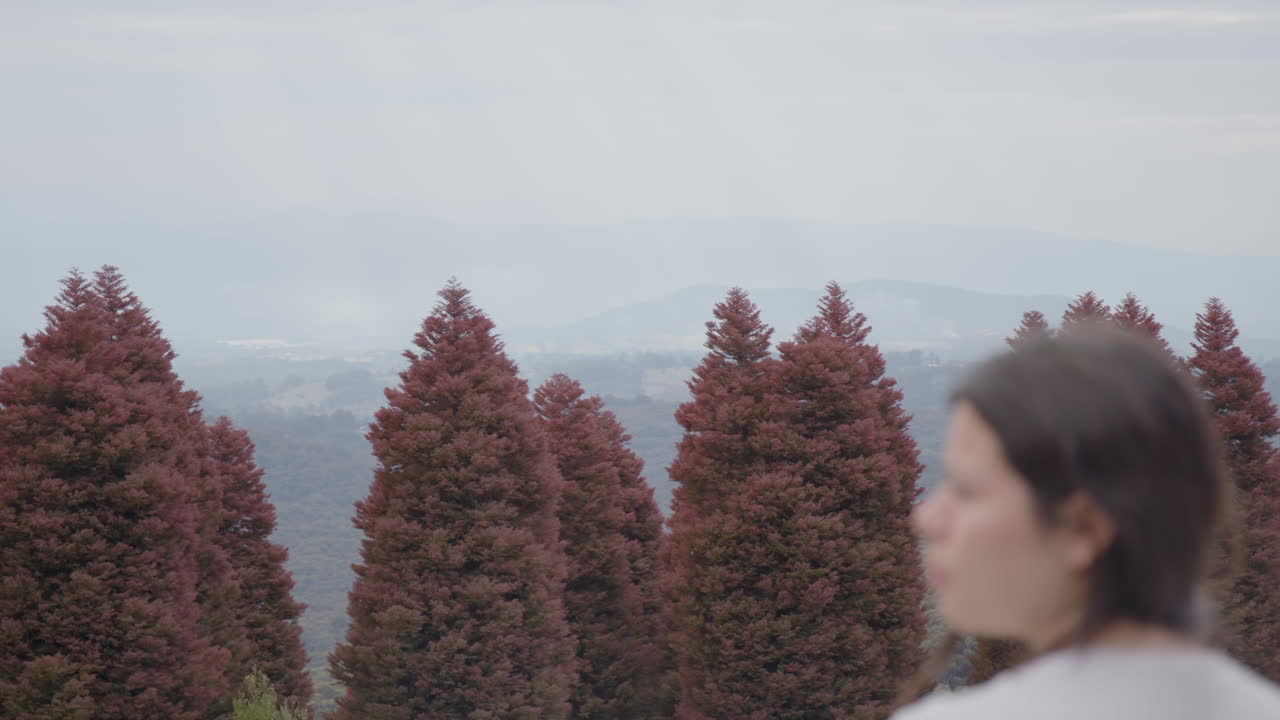 A young woman appears to be disorientated in a park