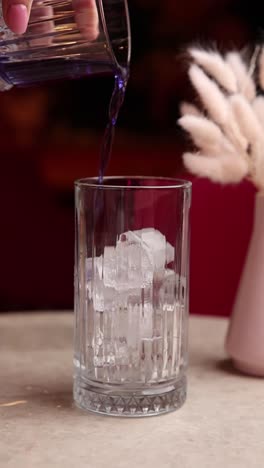 pouring a purple cocktail