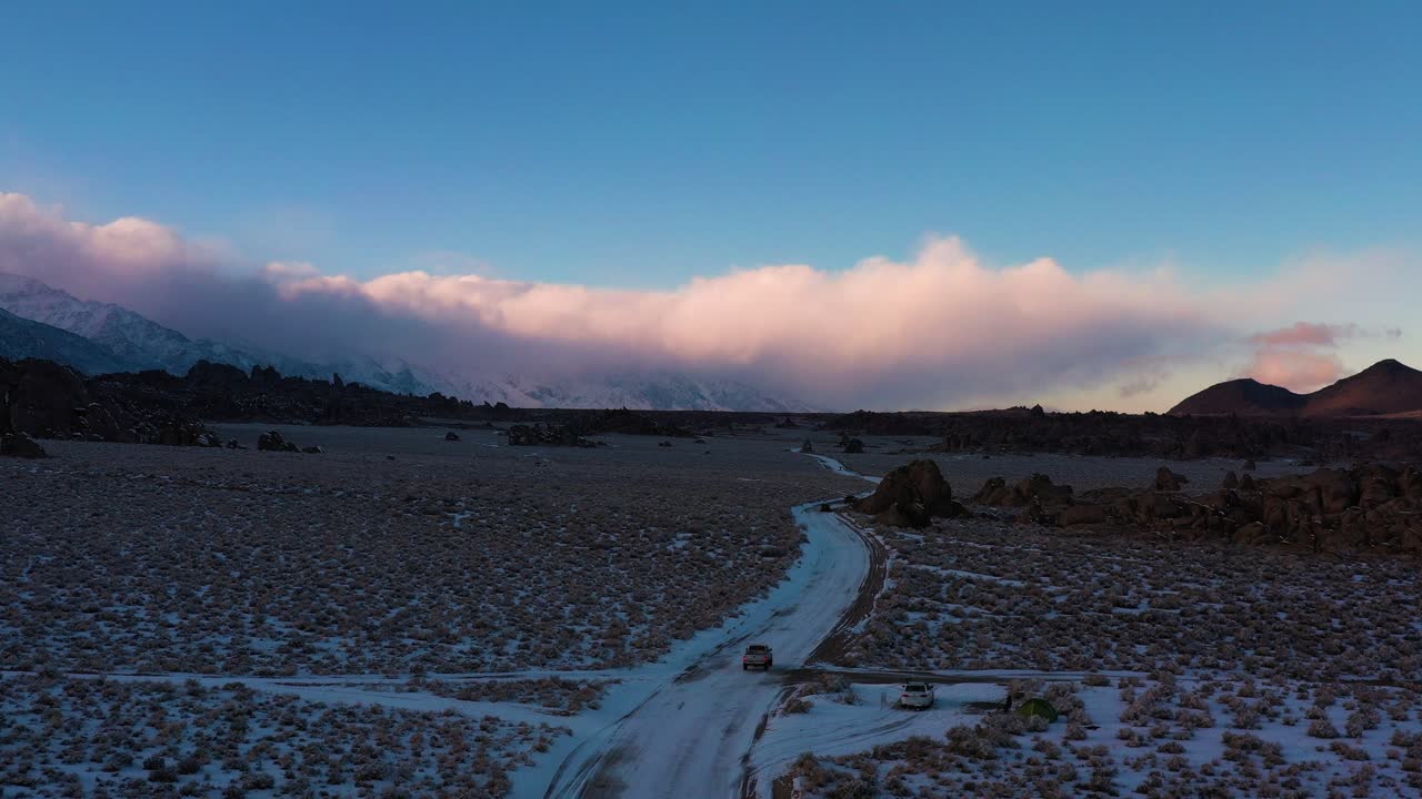 Vehicles Driving On Scenic Road In Snow At Winter In Alabama Hills, California. aerial drone