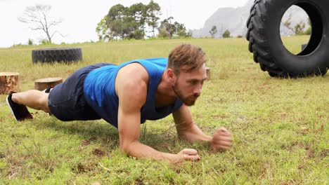 fit man exercising during obstacle course