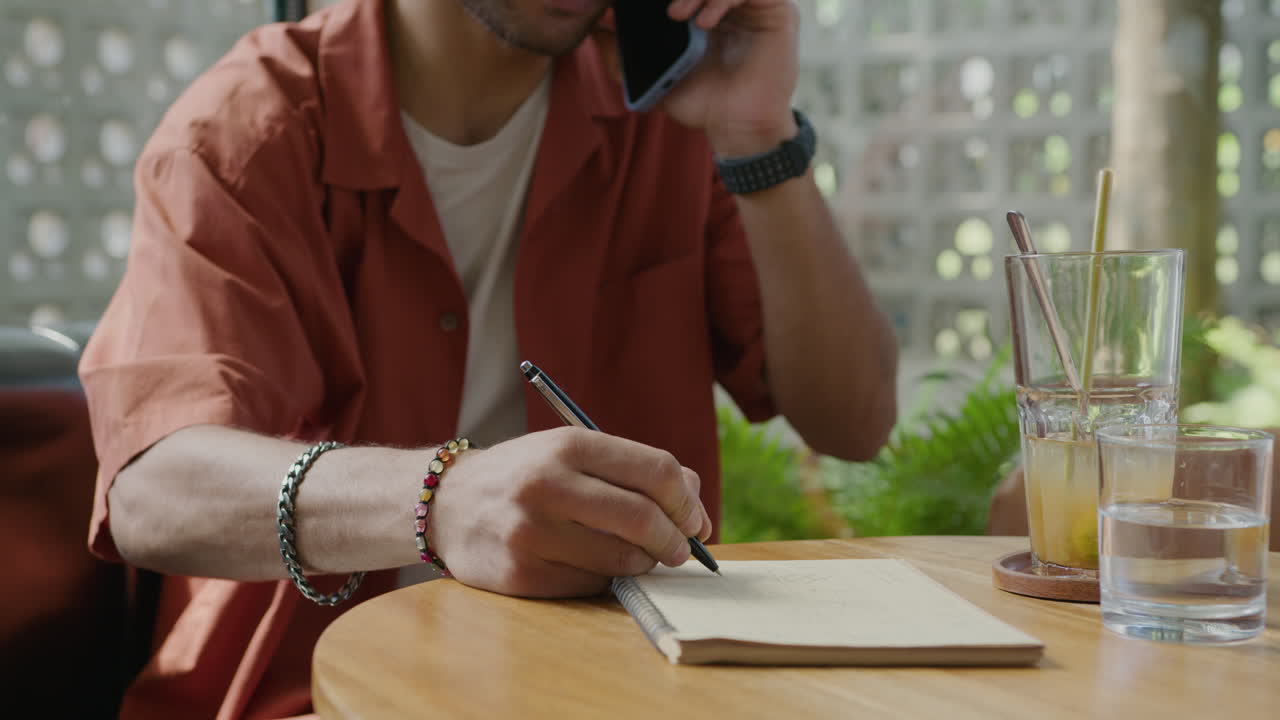 Male Hands Writing in Copybook