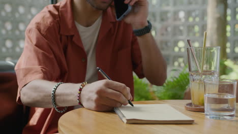 male hands writing in copybook