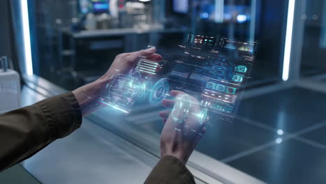 hands interacting with futuristic holographic interface in a lab
