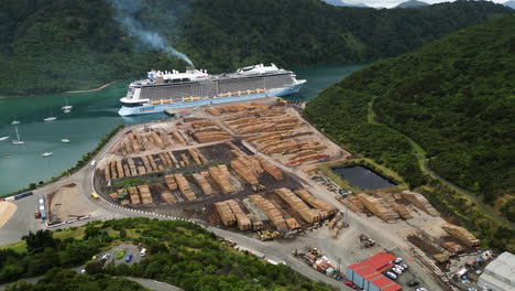 aerial circular view of the harbor of picton with cruise ship docked and a cargo of lumber on the quay