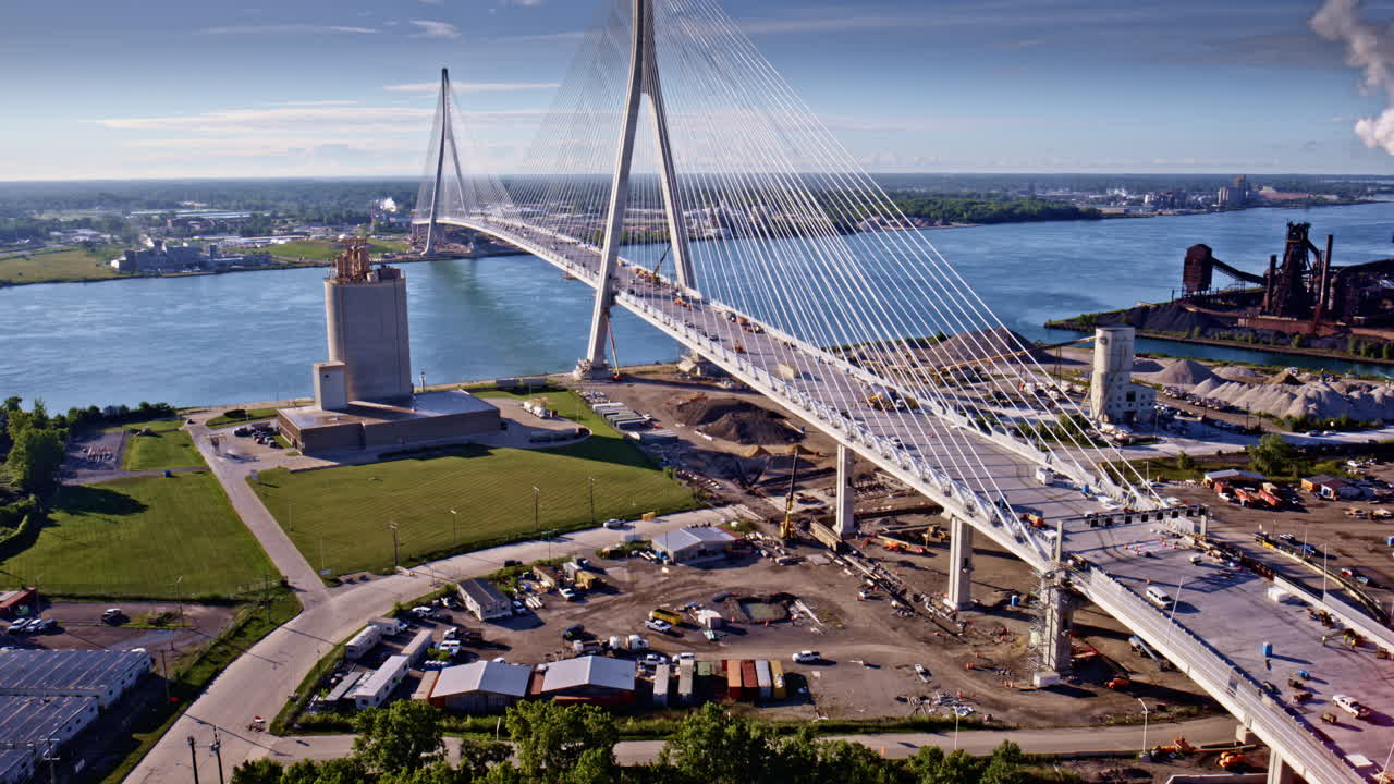 Cinematic aerial orbit capturing the bridge that spans the border of the U.S. and Canada