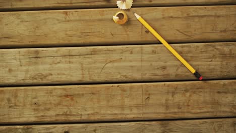 video of pencil and peels on wooden surface