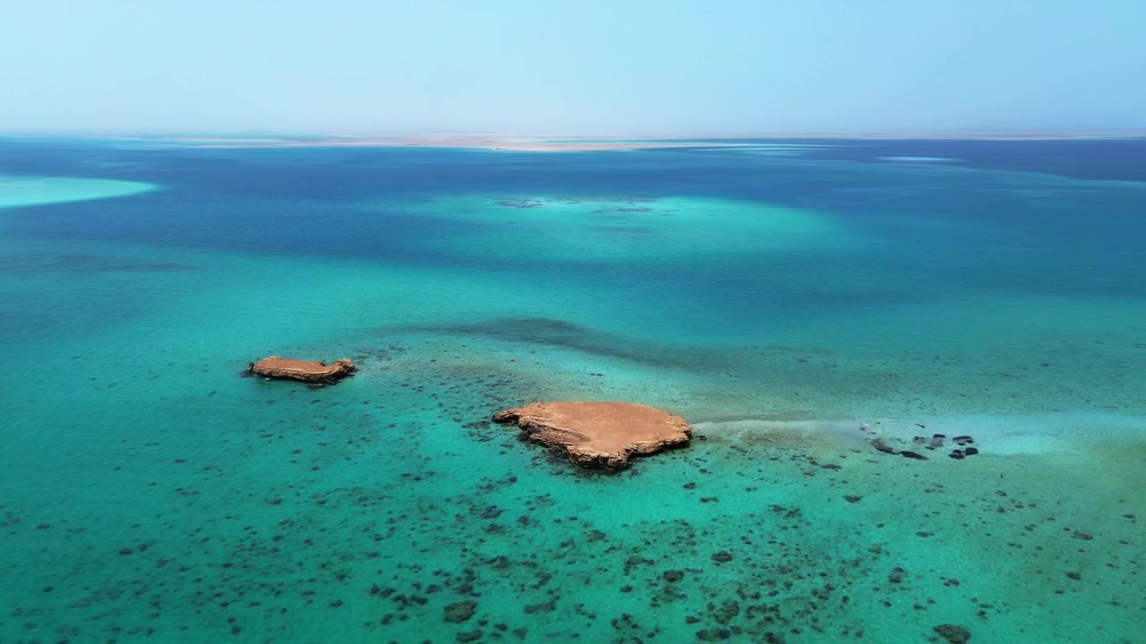 4K aerial footage capturing the beautiful turquoise waters and unique coral atoll formations in Dungunab Bay, Sudan, Africa.