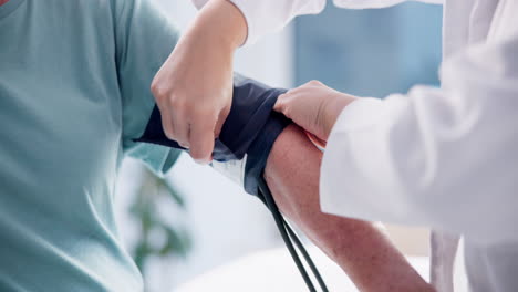 doctor, patient and blood pressure gauge on arm