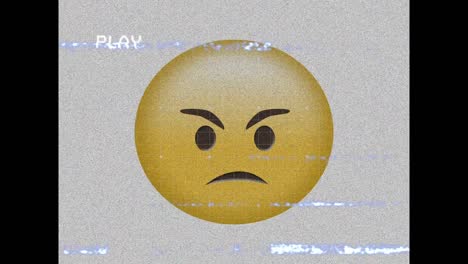 digital animation of vhs effect over angry face emoji against grey background