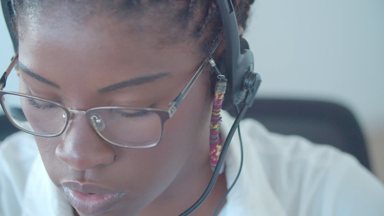 Focused African American call center worker with dreads