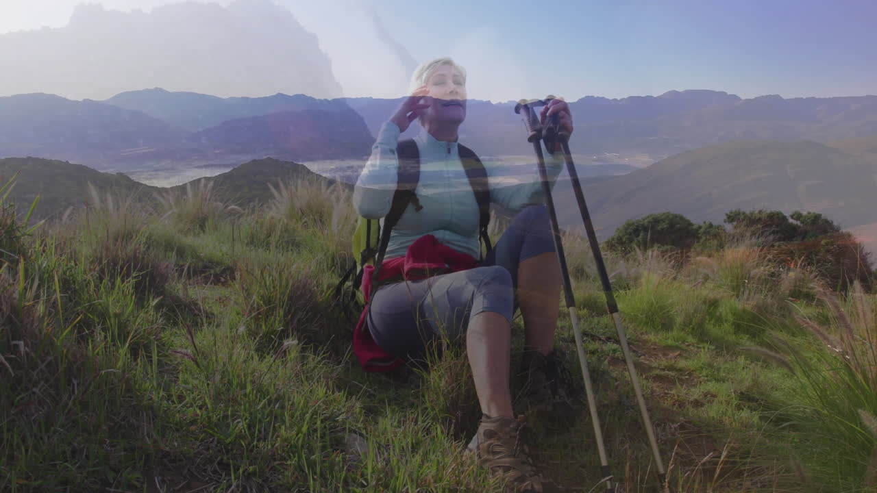 woman holding poles and scanning horizon on grassy hillside, with animated graph overlay for travel