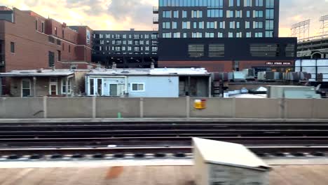 beautiful sunset over wrigley field as the cta train races by wrigley field.