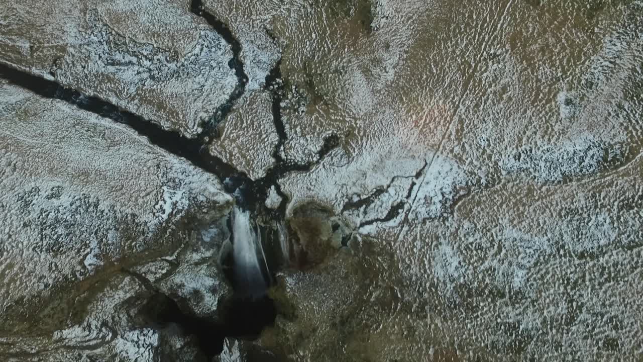 Amazing aerial flight over majestic waterfall in the country of Iceland.