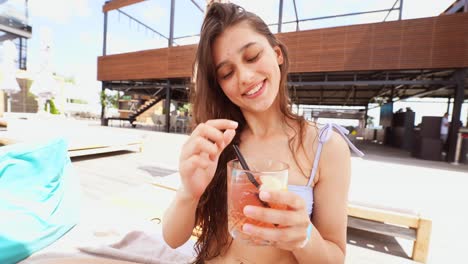 woman enjoying cocktails at a rooftop pool party