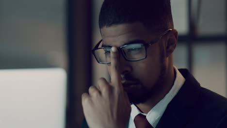 a young businessman using a laptop during a late