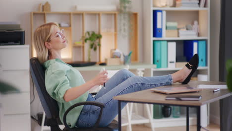 businesswoman enjoys high profits with feet on desk