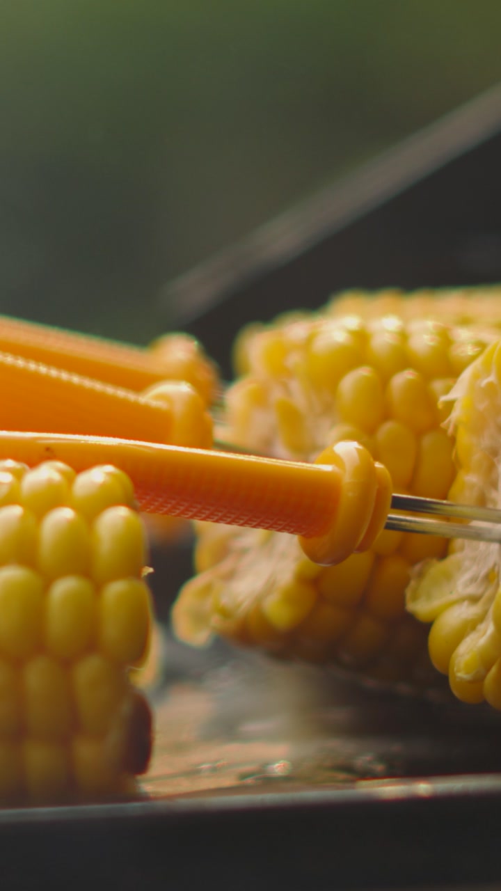 Vertical Video of Fresh Organic Sweetcorn Corn on the Cob with Smoke and Heat Distortion from BBQ Being Cooked Outside in Summer. Healthy Side Dish Snack.