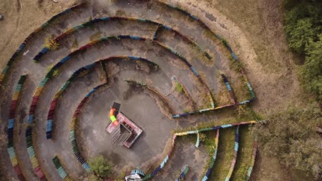 a dynamic ascending aerial shot of an empty kiddie labyrinth at a children's park in buenos aires, argentina