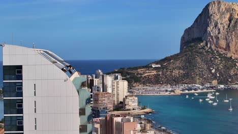 the calp coast with estimar hotel, beach, and surrounding landscape, aerial view