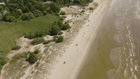 aerial tilt shot of rotating along the parnu beach, sunny, summer day in estonia