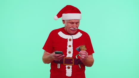 Christmas-grandfather-using-credit-bank-card,-smartphone-while-transferring-money-shopping-online