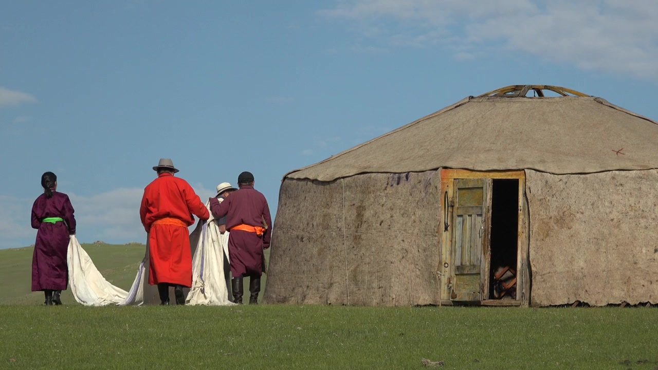 Mongolian Nomadic Family Assembling a Traditional Ger Tent