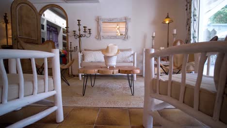 slow establishing shot of wooden furniture within a living room in a villa