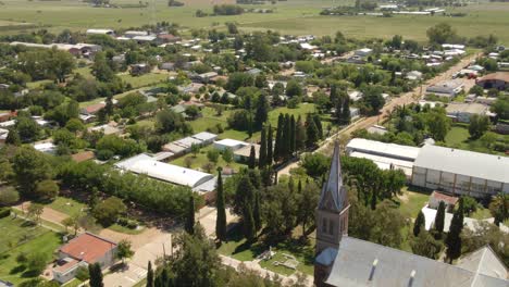 track left of a romantic style church with santa anita town in background, entre rios, argentina