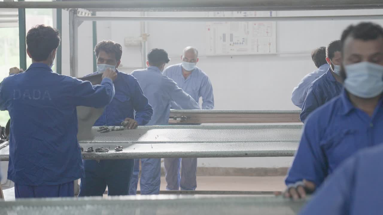 Close Up Shot Of Workers On The Production Line Of A Leather Factory In Pakistan.