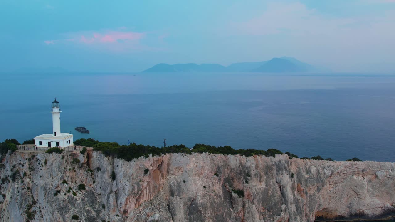 Aerial View Of Douk&aacute;to Lighthouse On Lefkada Cliff Edge With Island Misty Landscape Sea In Background