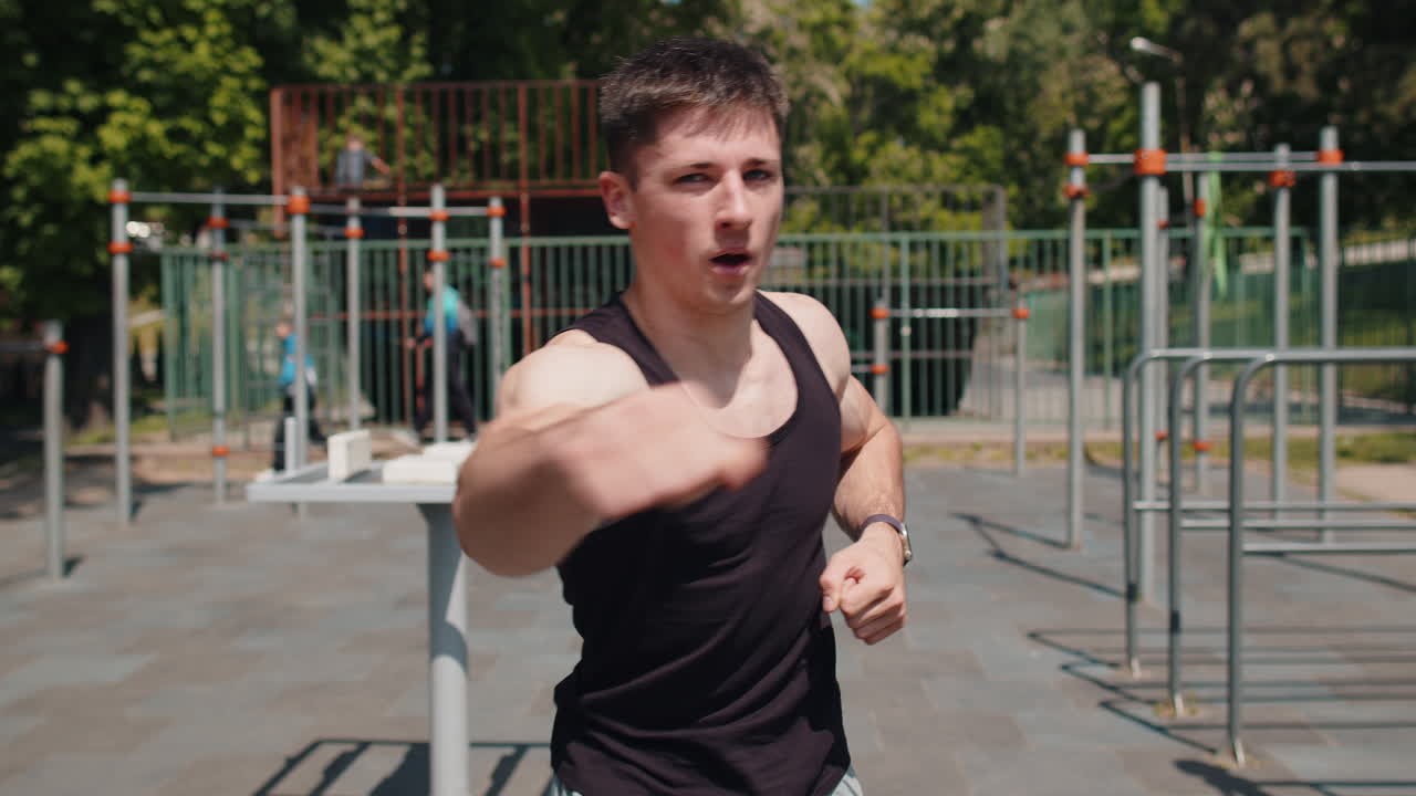 Athletic caucasian man in sportswear doing sport training shadow boxing fitness aerobics cardio