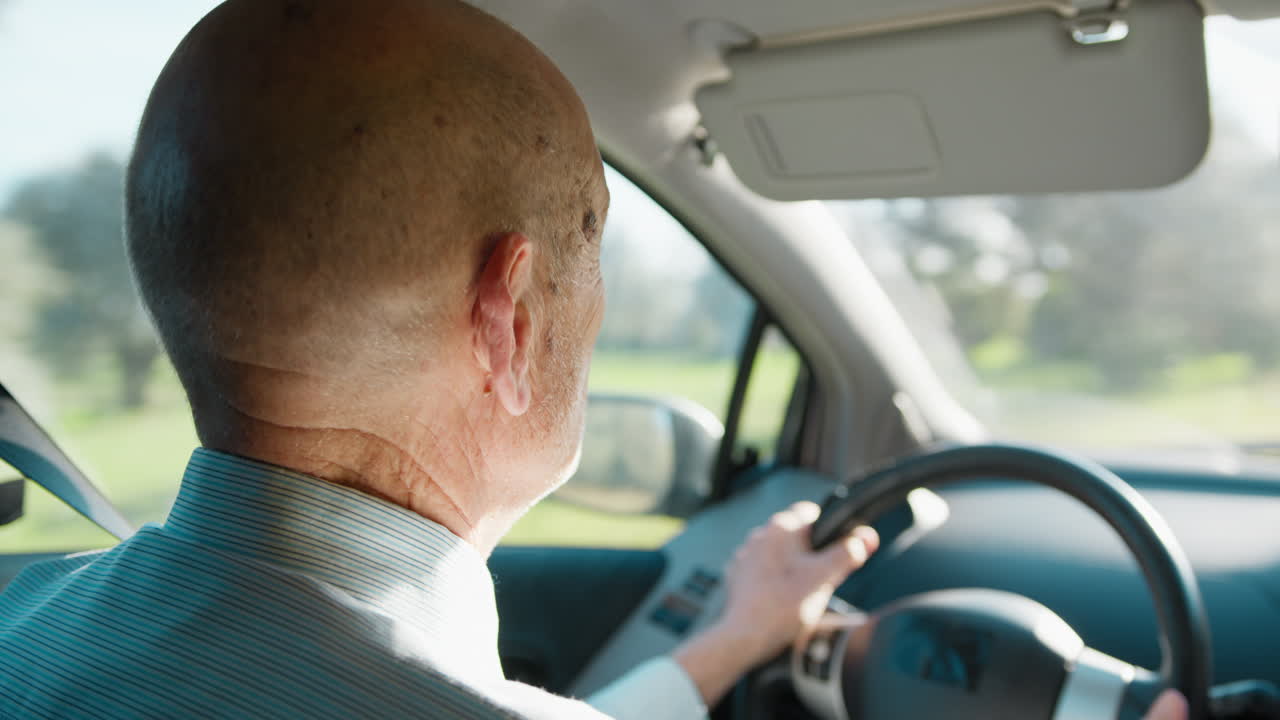 Elderly Man Driving the Car on a Sunny Day