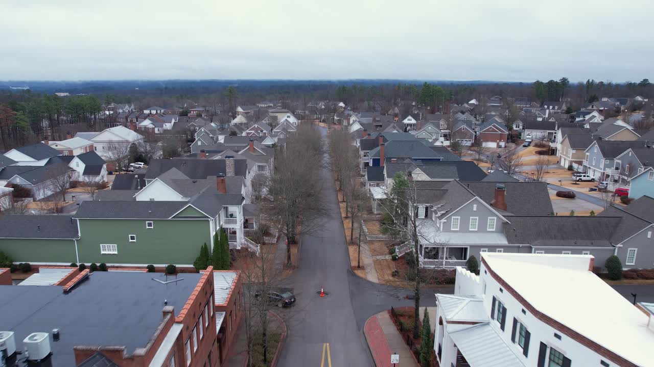 la antena se aleja y revela las pequeñas tiendas de la ciudad y la rotonda frente a la extensa área suburbana en moss rock preserve en hoover, alabama