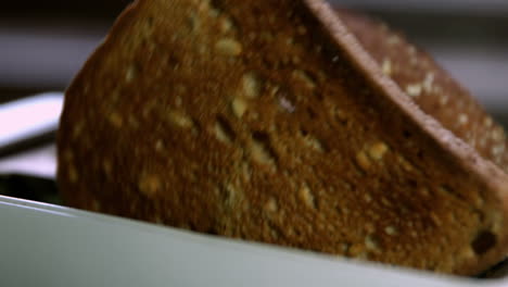 two slices of toast popping out of toaster in kitchen