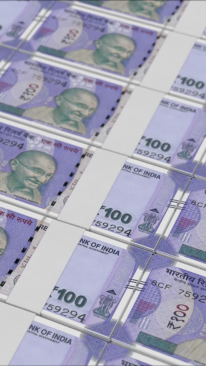 Vertical video of 100 RUPEES banknotes printing by a money press