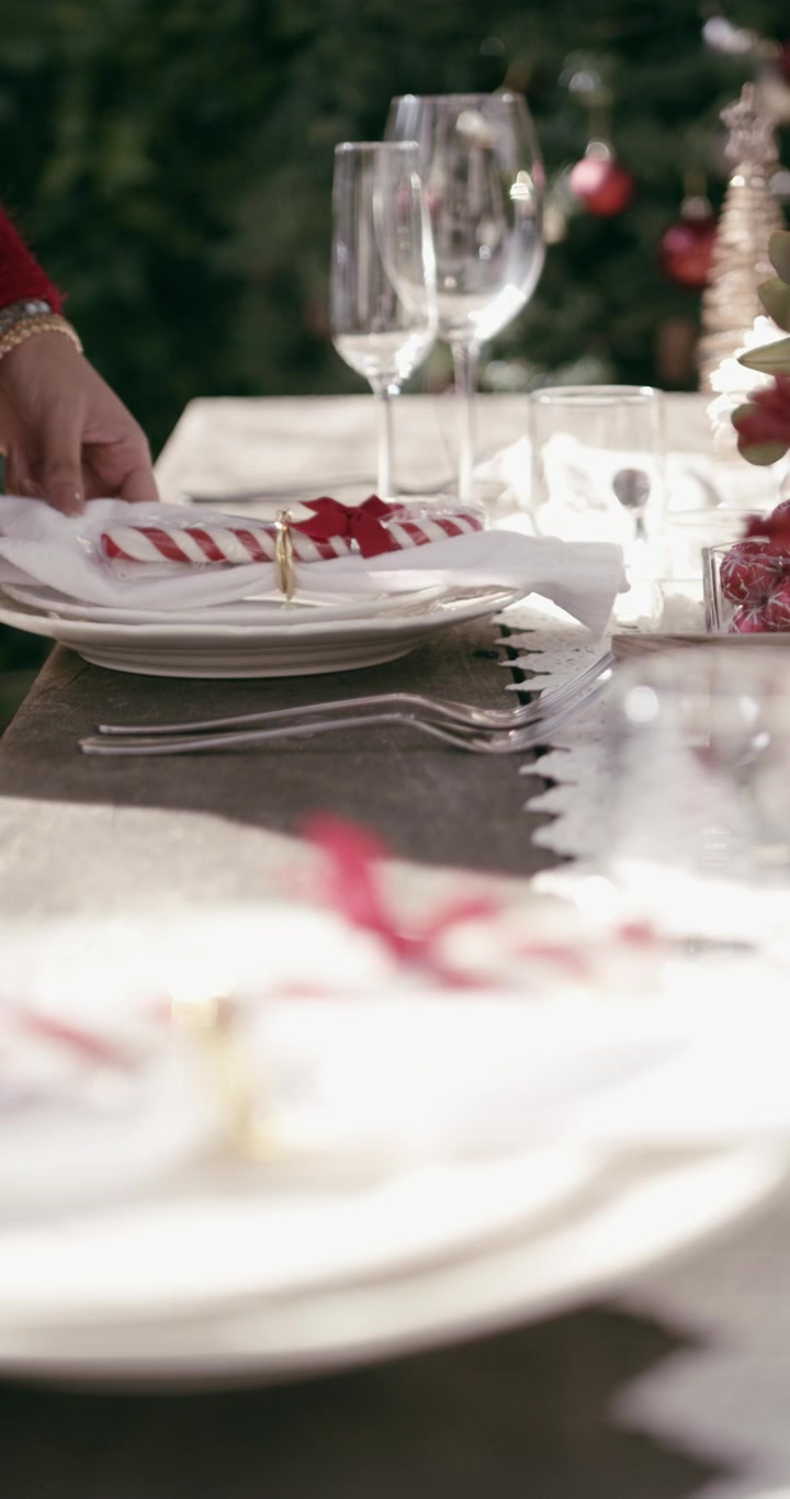 Woman Setting a Festive Christmas Table for Dinner
