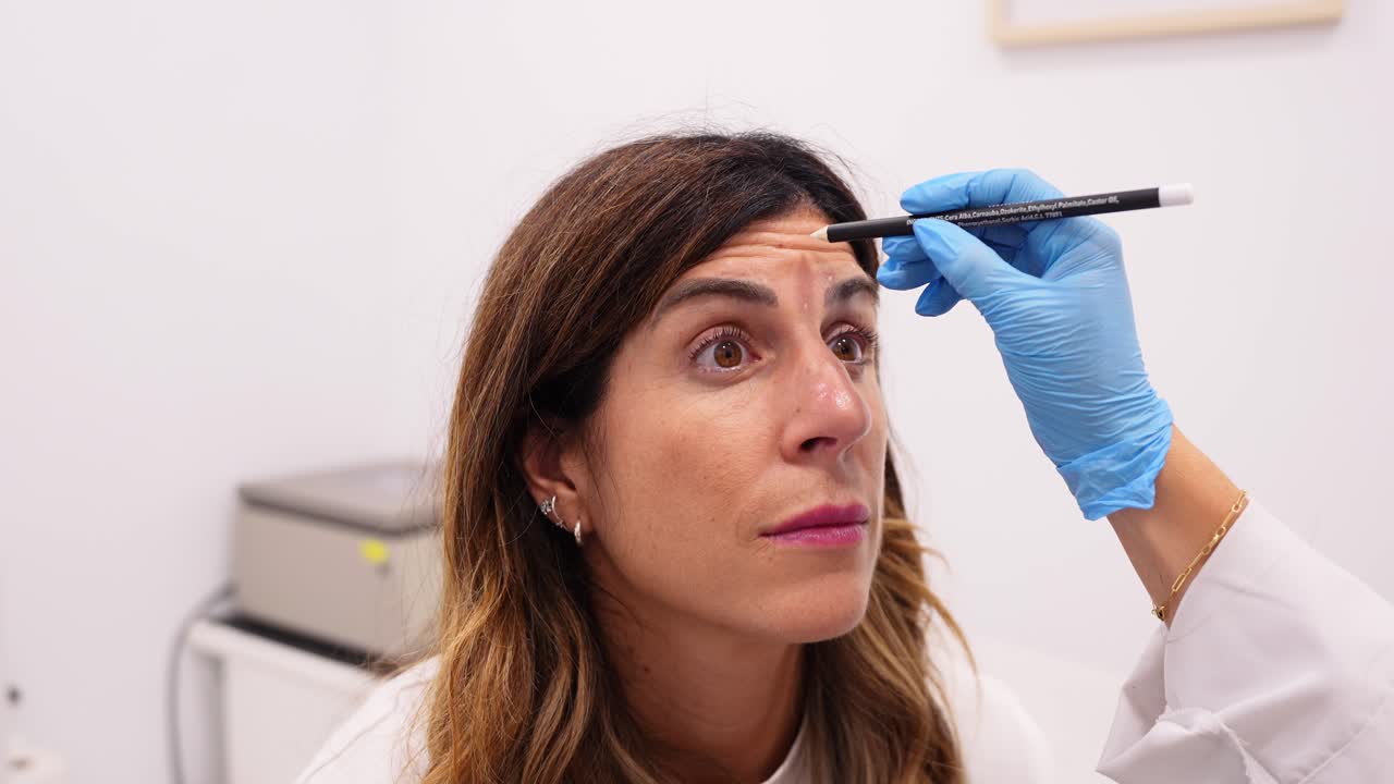 Medical and Cosmetic Procedure on a Woman's Forehead