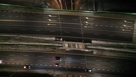 top down night city roads with cars driving aerial view