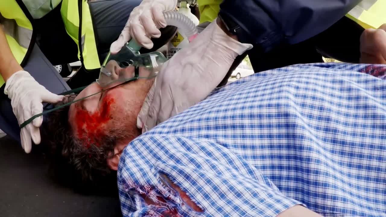 Paramedic using an external defibrillator during cardiopulmonary resuscitation