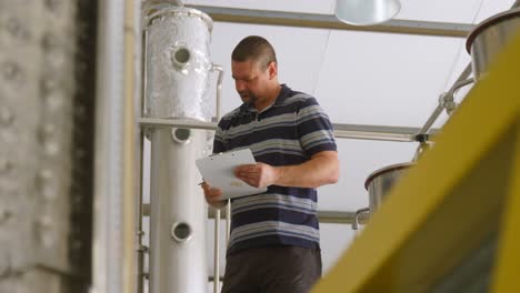 Male-worker-writing-on-a-clipboard-4k