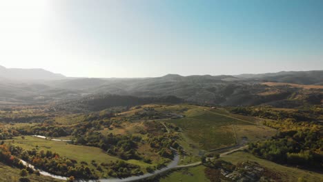 Aerial-panning-shot-of-big-green-valley-at-sunset